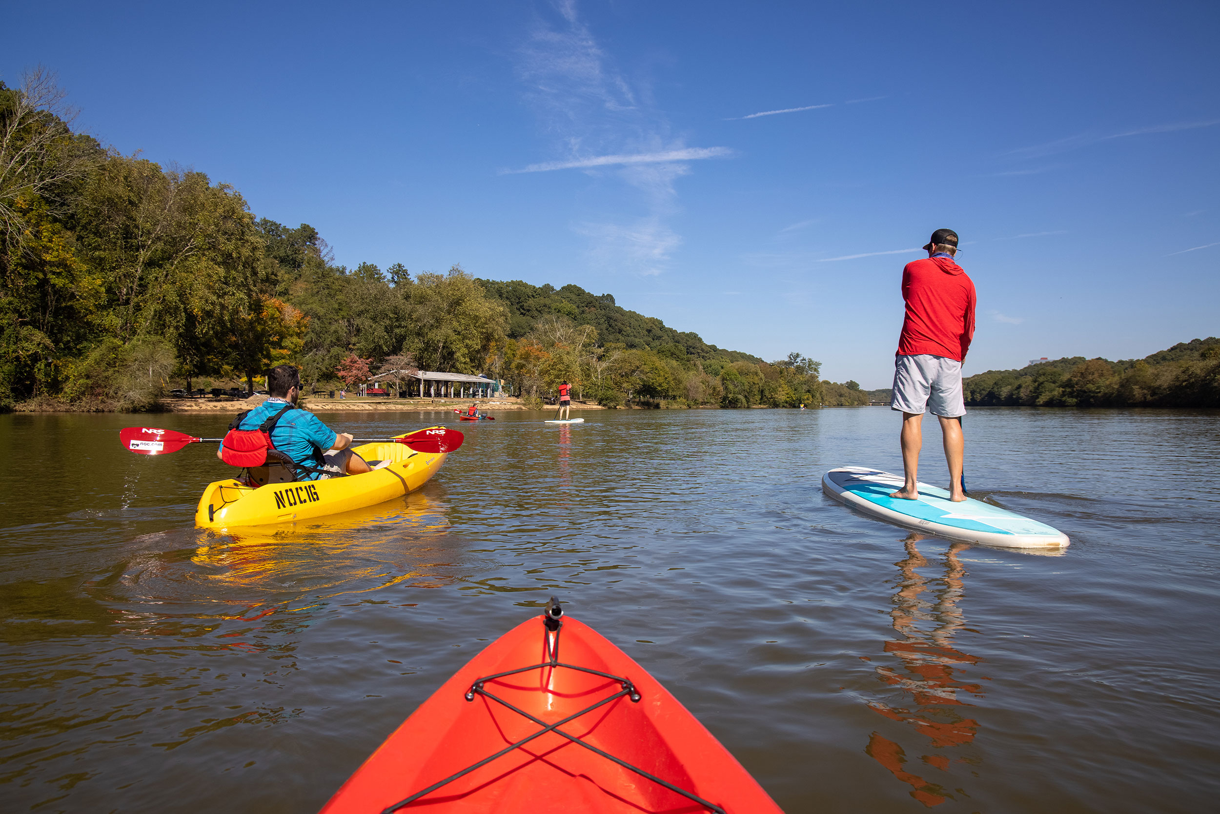 People on the water via kayak or paddle board at the Nantahala Outdoor Center